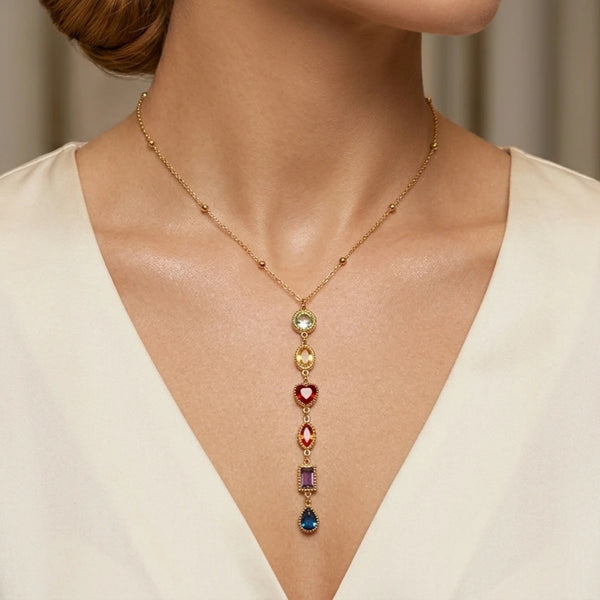 Découvrez le collier Joy Rayonnante porté. Admirez sa cascade de pierres multicolores sur une chaîne dorée élégante. Un bijou vibrant pour illuminer votre décolleté.
