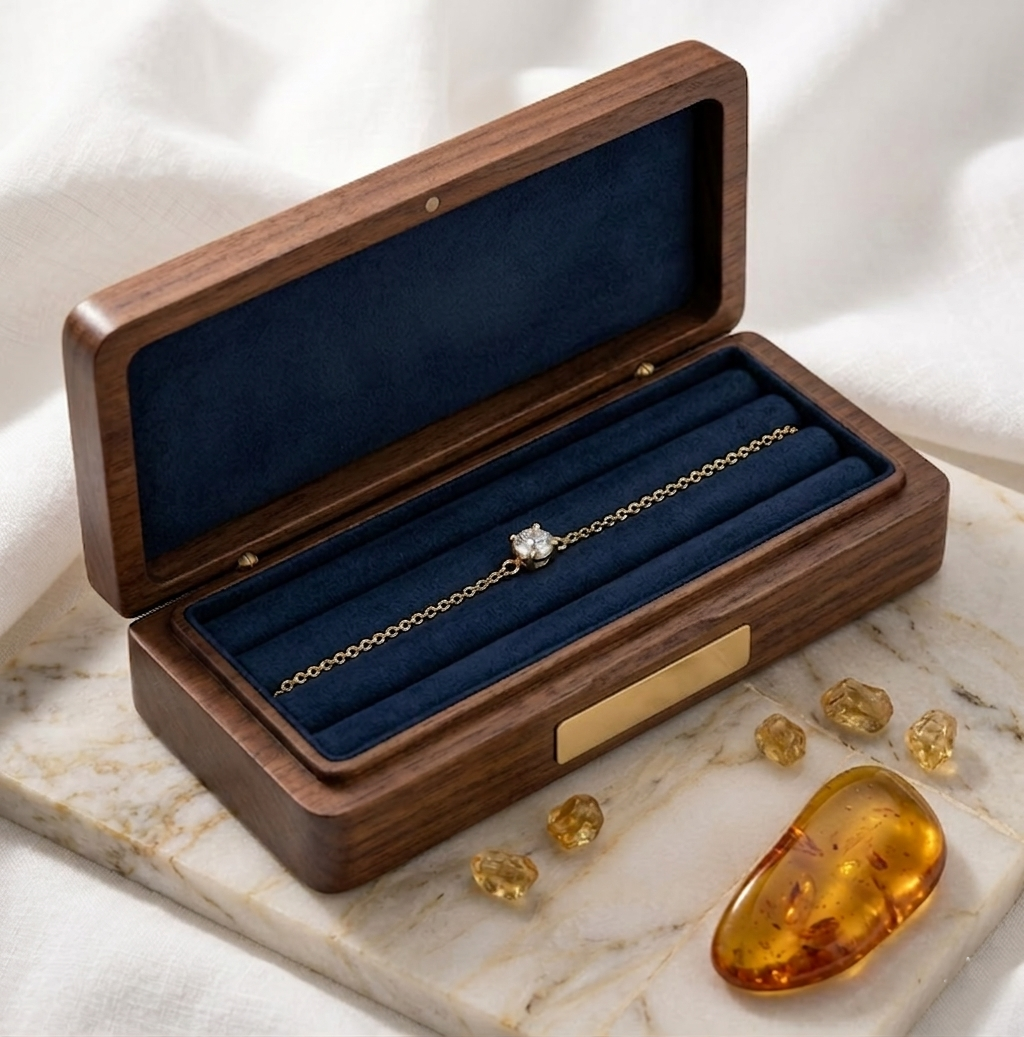 Bracelet doré Isaline Scintillante présenté dans son coffret en bois précieux ouvert avec décorations minérales chaudes.